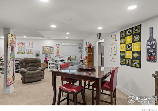 carpeted dining room featuring ceiling fan