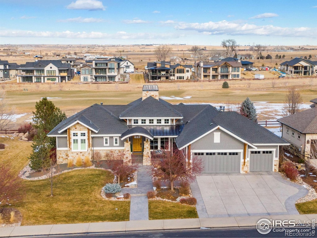 view of front of home with a front yard and a garage