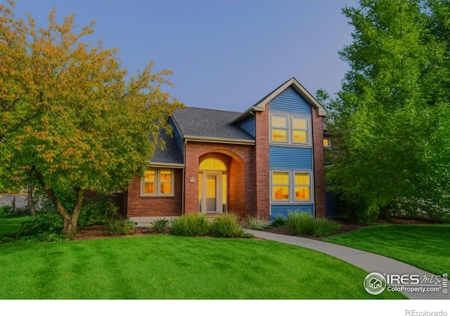 6345 Swallow Ln, Boulder, CO 80303 - traditional home featuring brick siding, a front yard, and a shingled roof