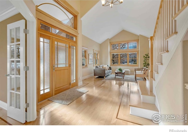 6345 Swallow Ln, Boulder, CO 80303 - entrance foyer featuring hardwood / wood-style floors, stairs, high vaulted ceiling, and a chandelier