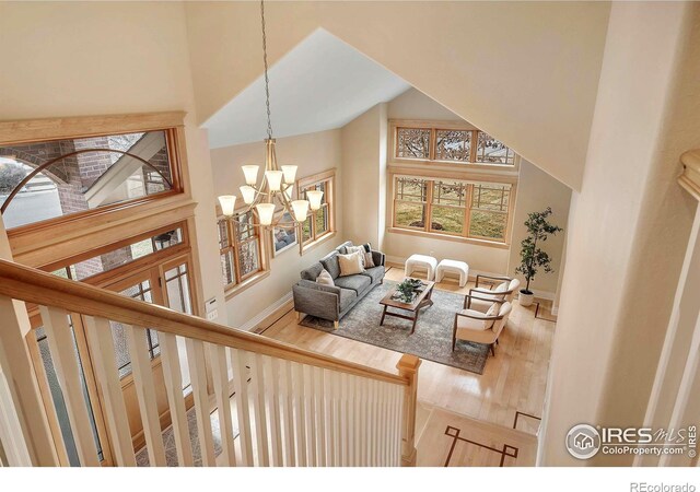 6345 Swallow Ln, Boulder, CO 80303 - living room featuring a chandelier, a towering ceiling, and wood finished floors