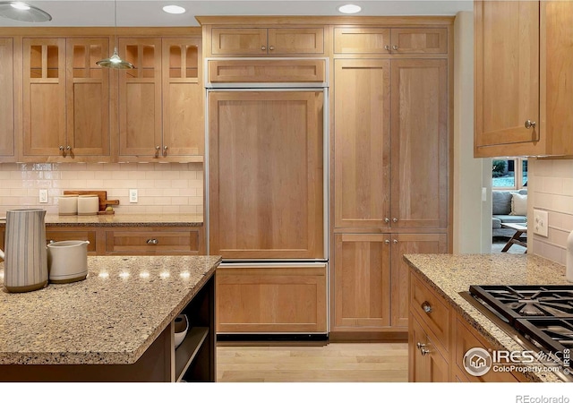 6345 Swallow Ln, Boulder, CO 80303 - kitchen featuring paneled built in refrigerator, decorative backsplash, hanging light fixtures, stainless steel gas cooktop, and light wood finished floors