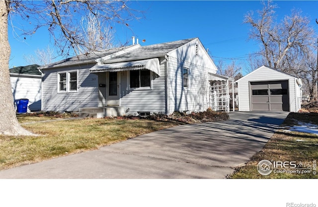 view of front of property with a garage, a front yard, and an outdoor structure