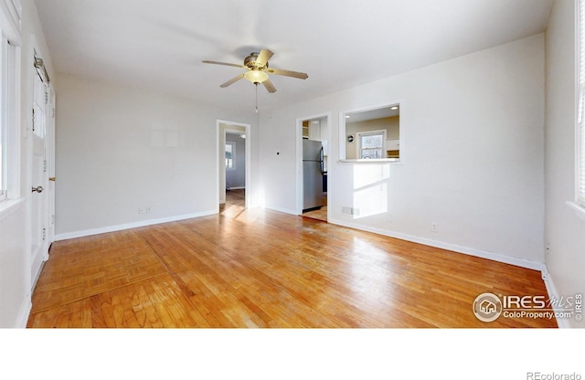 empty room featuring ceiling fan and light hardwood / wood-style flooring