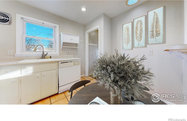 kitchen featuring white cabinets, light tile patterned floors, sink, and white dishwasher