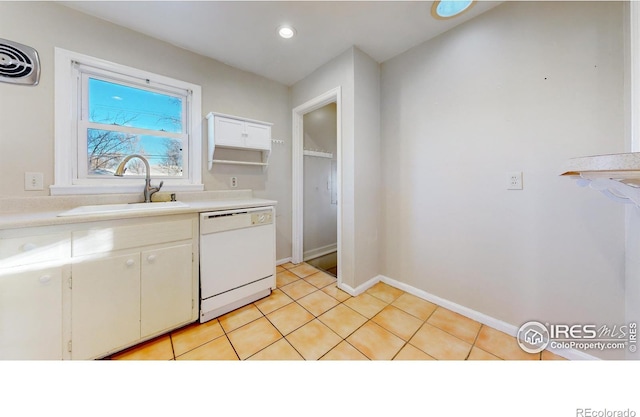 kitchen featuring light tile patterned flooring, white cabinetry, dishwasher, and sink