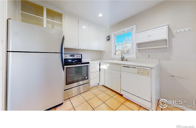 kitchen with refrigerator, sink, white dishwasher, white cabinetry, and stainless steel electric stove