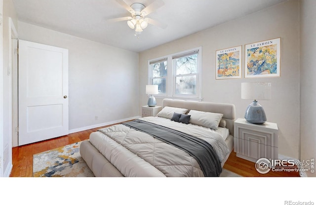 bedroom with light wood-type flooring and ceiling fan