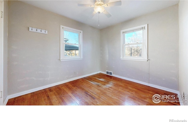 unfurnished room with ceiling fan and wood-type flooring