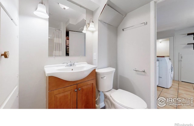 bathroom featuring tile patterned floors, vanity, toilet, and washing machine and clothes dryer