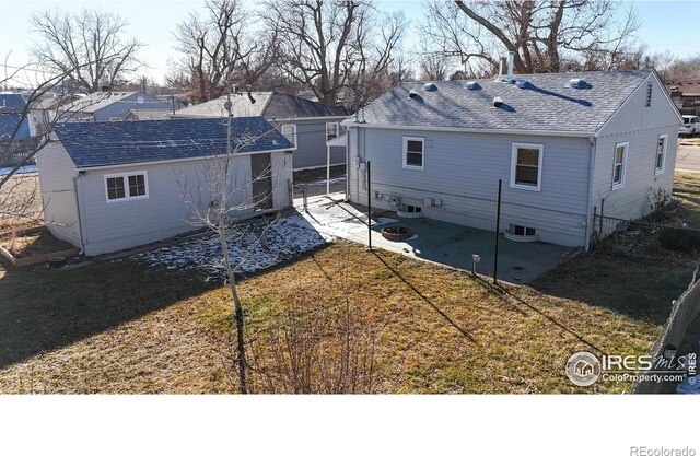 rear view of house featuring a lawn