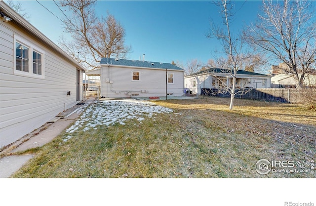 rear view of house with a patio area and a lawn