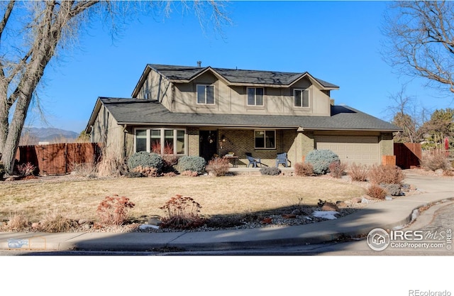 view of front of home with a garage and a front lawn