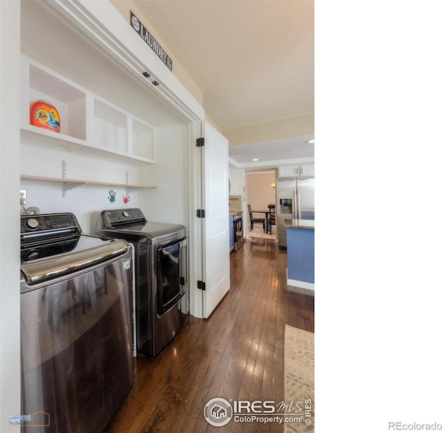 laundry area with separate washer and dryer and dark hardwood / wood-style flooring