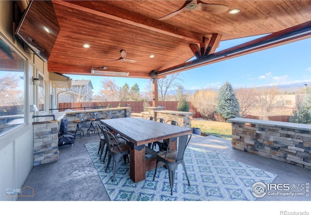 view of patio / terrace with ceiling fan and exterior bar