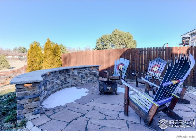 view of patio with a fire pit