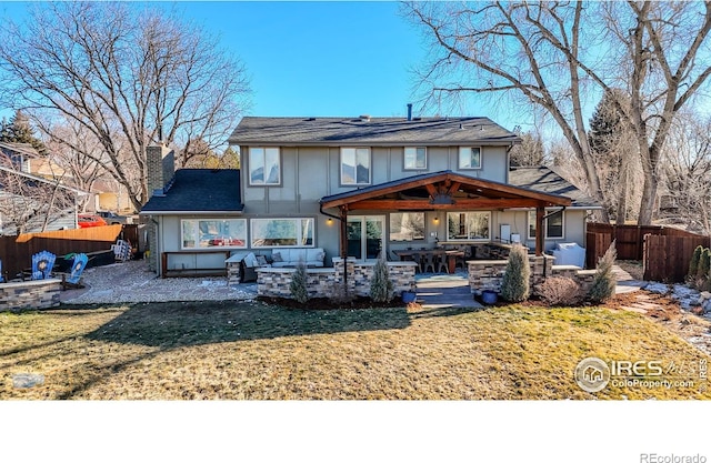 rear view of property with a lawn and a patio