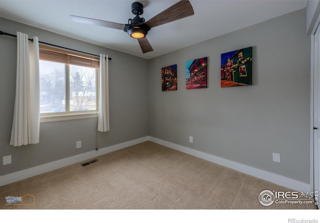 unfurnished room with ceiling fan and carpet floors