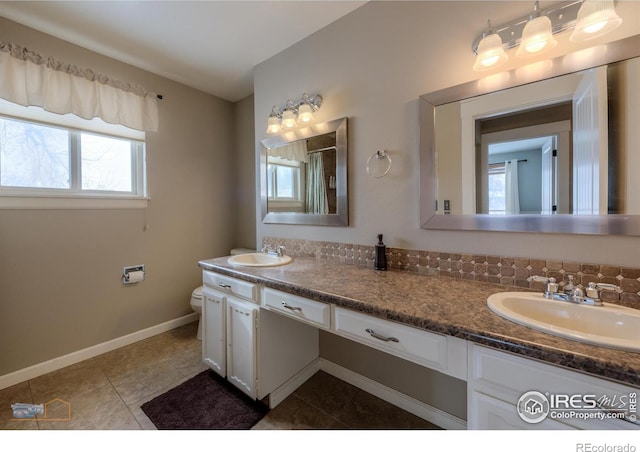 bathroom featuring toilet, vanity, and tile patterned floors