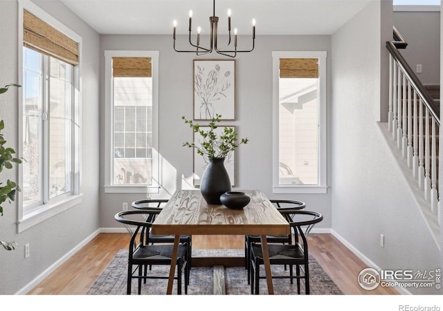 dining room featuring hardwood / wood-style flooring, plenty of natural light, and a notable chandelier