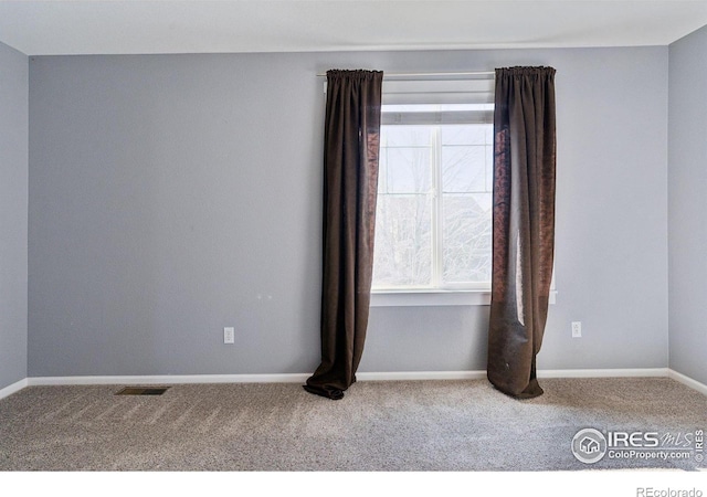 unfurnished room featuring carpet flooring