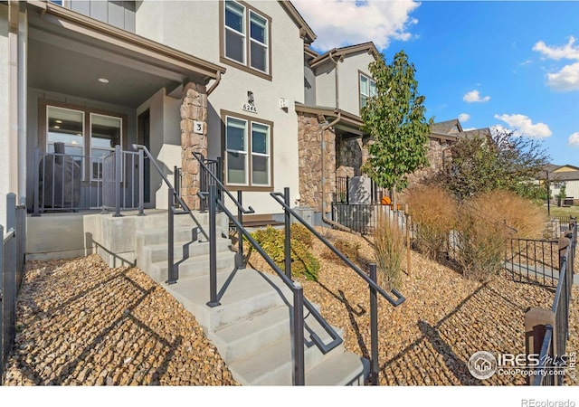 view of front of home featuring fence and stucco siding