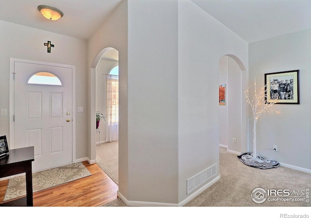 foyer entrance with light hardwood / wood-style flooring