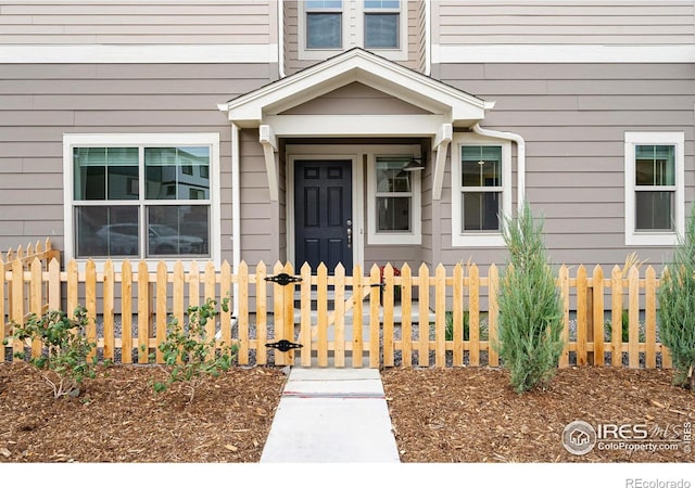 view of exterior entry with fence