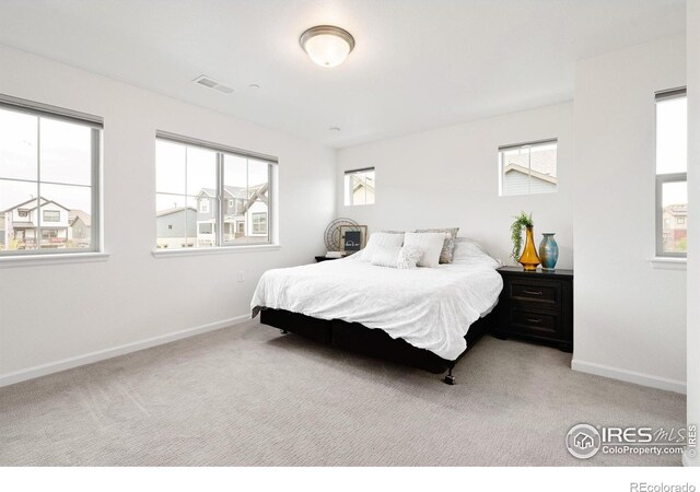 bedroom featuring baseboards, visible vents, and carpet flooring