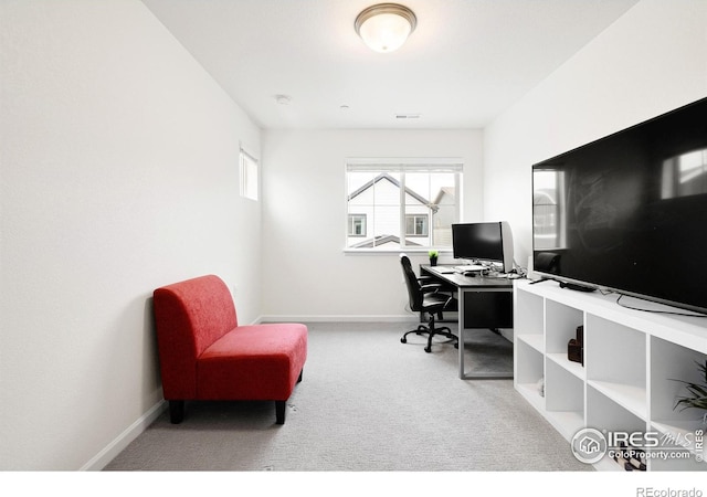 carpeted office featuring visible vents and baseboards