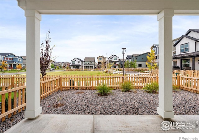 view of patio featuring fence private yard and a residential view