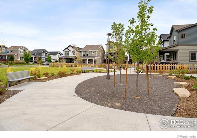 surrounding community featuring a residential view, fence, and a yard