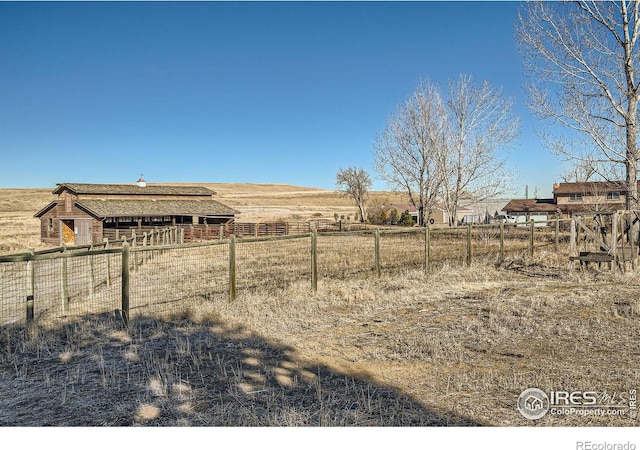 view of yard with a rural view