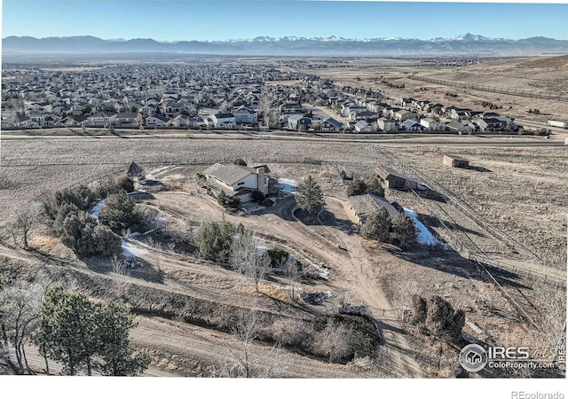 birds eye view of property with a mountain view