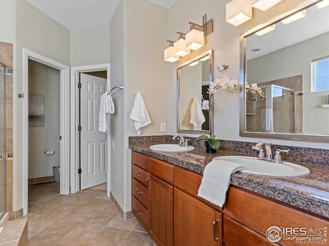 bathroom with a shower with shower door and vanity