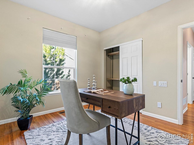 office with plenty of natural light and hardwood / wood-style floors