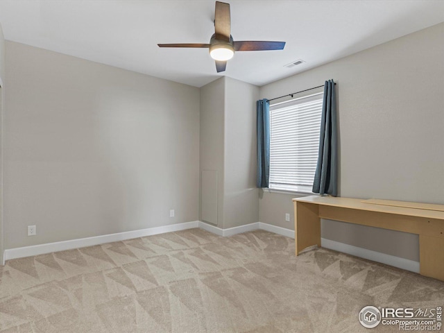 unfurnished room featuring ceiling fan and light colored carpet