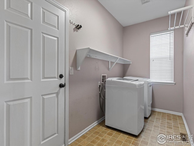 laundry room with washer and dryer and a healthy amount of sunlight