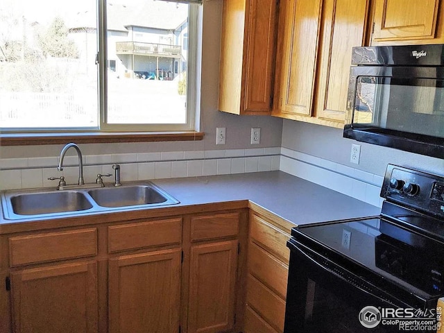 kitchen featuring sink and black appliances