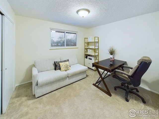 office with baseboards, carpet floors, and a textured ceiling