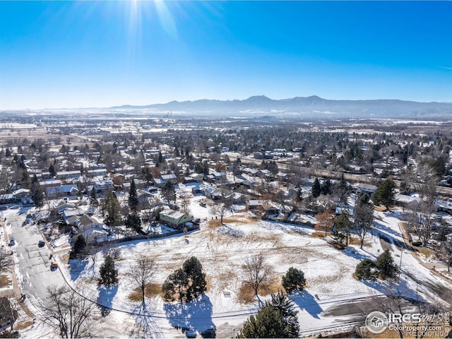 snowy aerial view featuring a mountain view