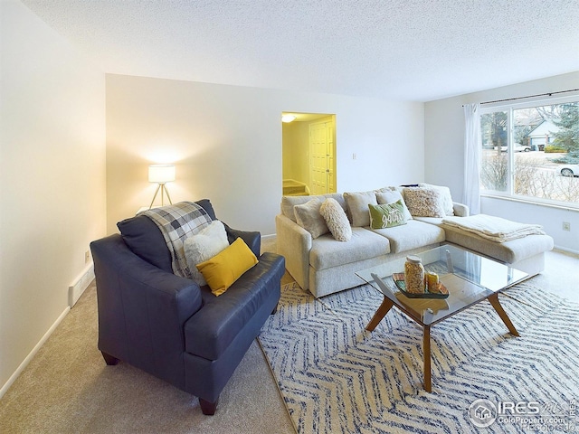 carpeted living room featuring stairway, a textured ceiling, and baseboards