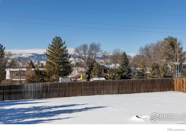 view of yard featuring a mountain view and fence