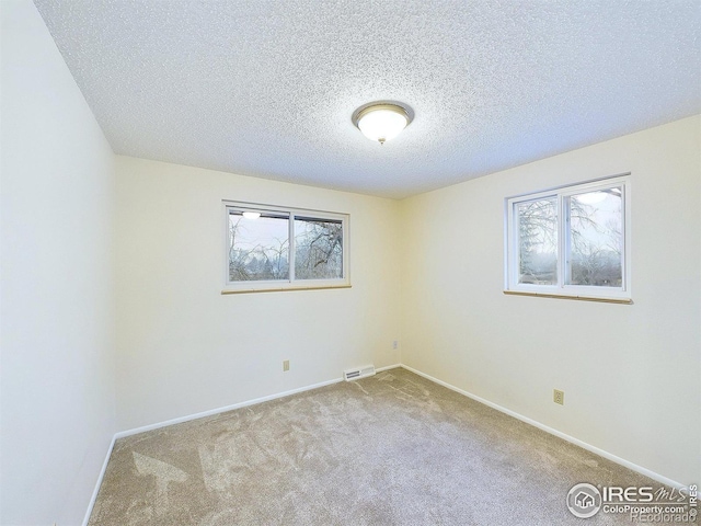 4667 Ashfield Dr, Boulder, CO 80301 - unfurnished room featuring carpet flooring, healthy amount of natural light, and a textured ceiling