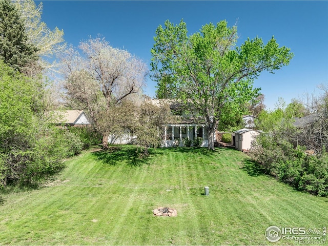 4667 Ashfield Dr, Boulder, CO 80301 - view of grassy yard featuring a storage unit