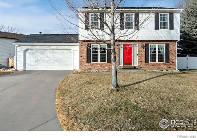 view of front of house featuring a front yard and a garage