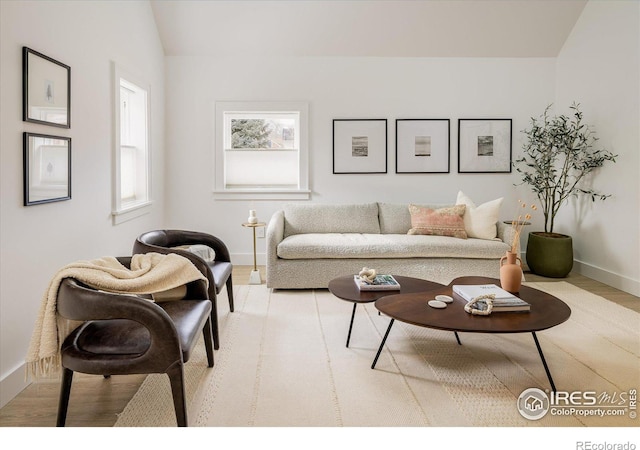 living room with vaulted ceiling and light hardwood / wood-style floors