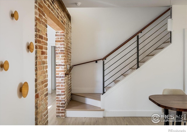 stairs featuring hardwood / wood-style floors