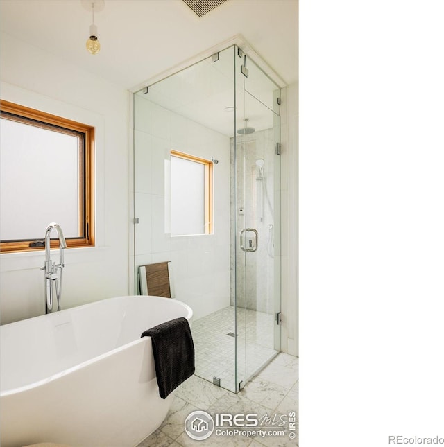 bathroom with separate shower and tub