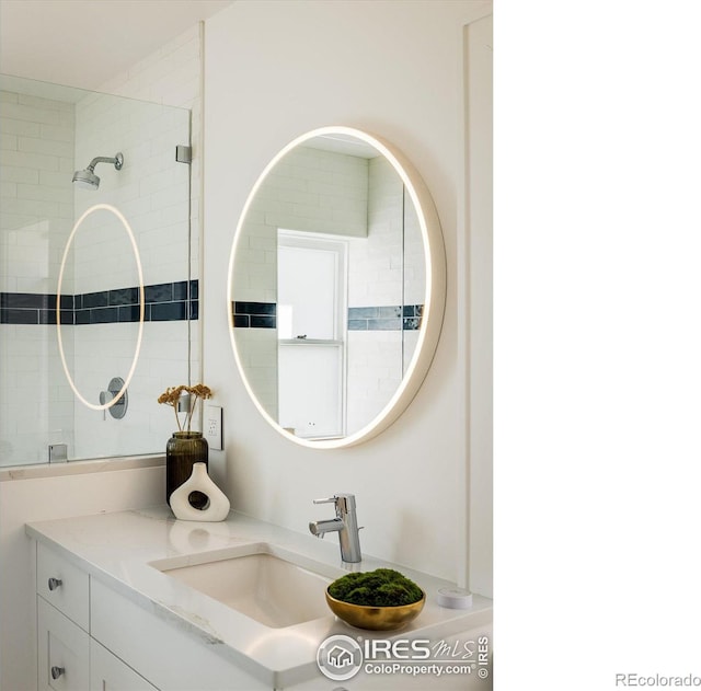 bathroom with vanity and a shower with door